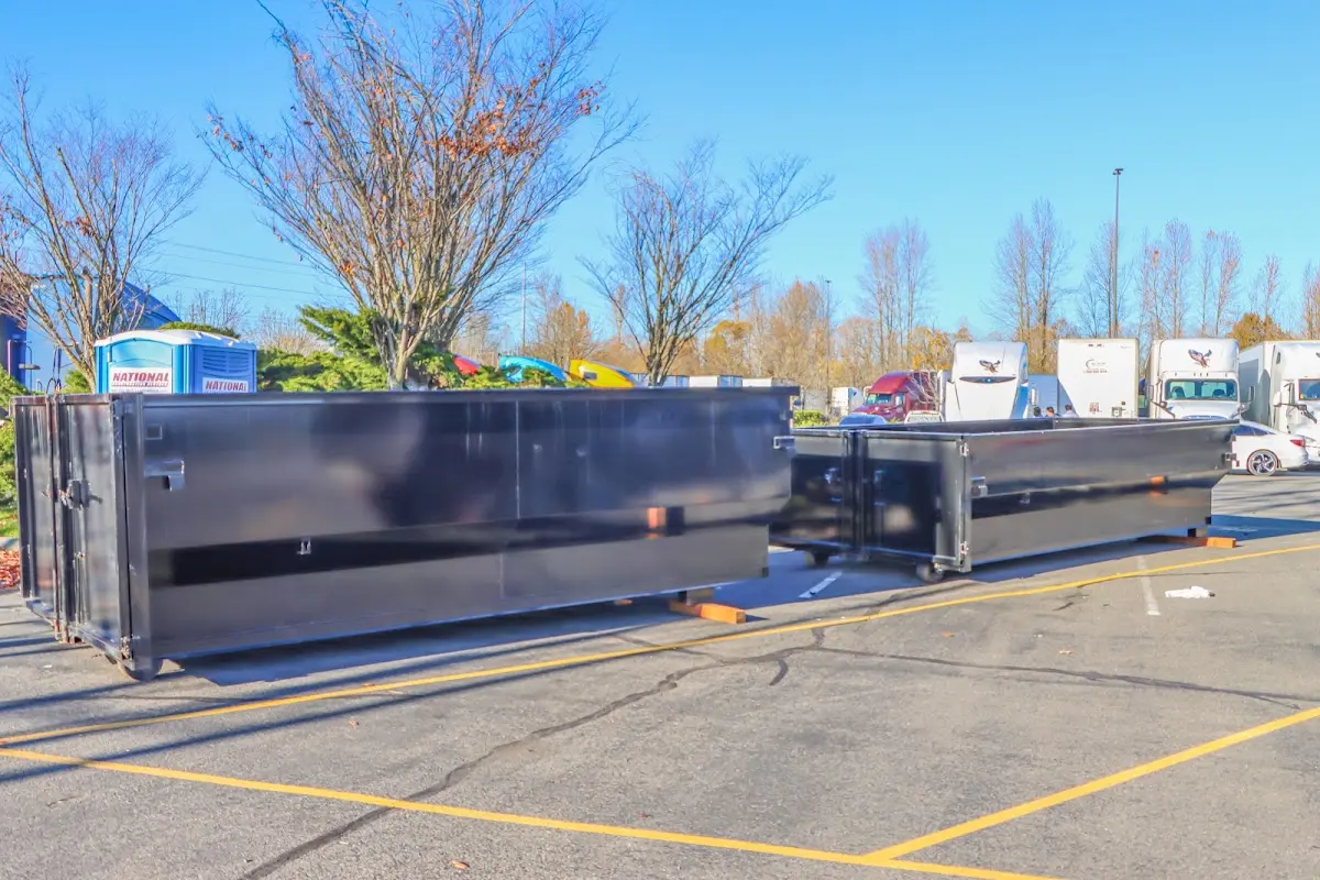 Professional dumpster rental service with roll-off container on residential driveway in Lakeport